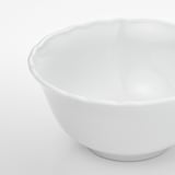Smooth, durable porcelain bowl with subtle ruffled edge. Perfect for everyday use.