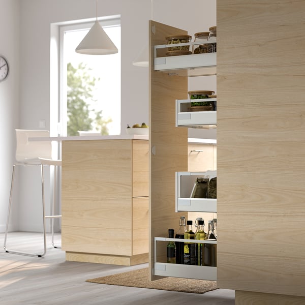 Modern kitchen with wooden cabinets; pull-out storage solution holds bottles, jars, and containers, optimizing space and visibility.