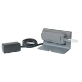 The UTRUSTA push opener device: grey, rectangular box with power adapter and cord.
