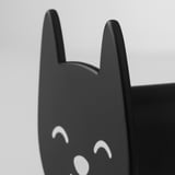 Black cat-shaped hook with white smiling eyes, perfectly crafted and modern, ideal for practical and decorative use.