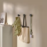 Decorative cat-shaped wall hooks holding coat, bag, and keys; part of UTSÅDD series, designed to organize and store everyday items creatively.