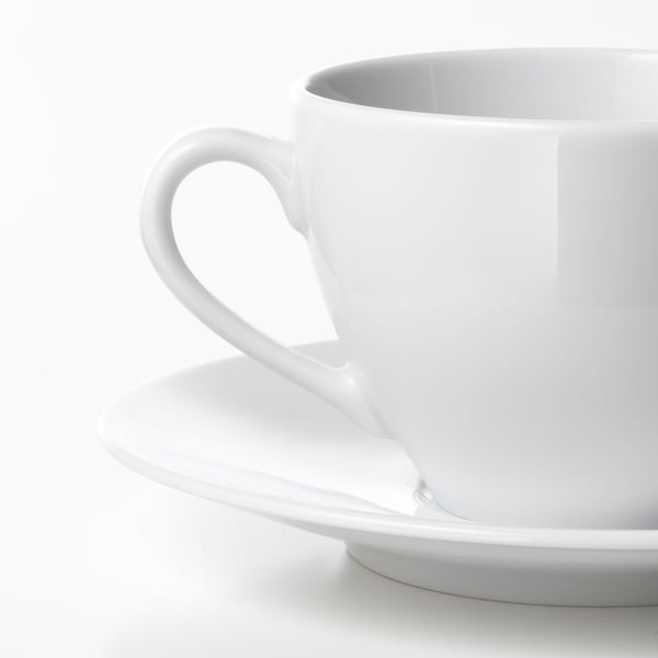 High-quality white porcelain cup, smooth handle, sits on matching saucer.