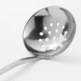 Silver metal skimmer with perforated bowl, long handle. Ideal for straining and lifting food from pots. Excellent quality and robust design.
