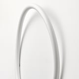 A sleek, white, circular led wall lamp emits a soft glow. Modern design, high-quality materials.