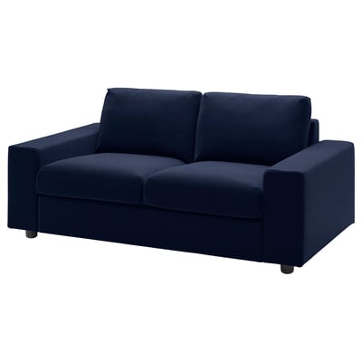A VIMLE navy blue, 2-seater sofa with a velvet cover, rectangular shape, and wooden legs.