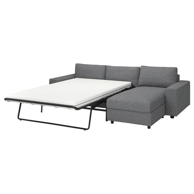 Modern gray sofa-bed with chaise, removable cover, metal frame.