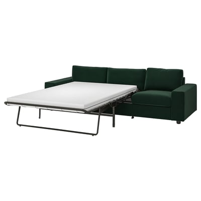 VIMLE dark green sofa-bed, modern design, sleek lines, padded cushions. Convertible, shows as bed.