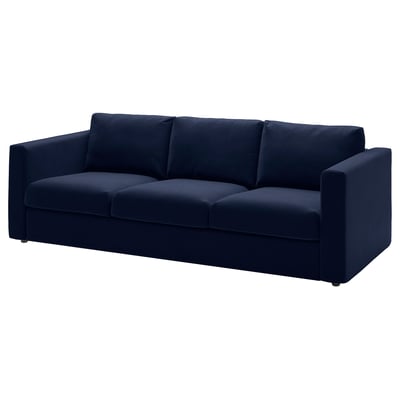 A modern navy blue VIMLE sofa with a sleek design, round edges, and loose cushions.