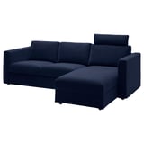 Modern dark blue l-shaped sofa with storage, plush cushions, & minimalist design.