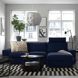 Modern living room with blue VIMLE sectional, city views, and striped rug.