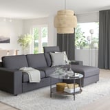 Modern living room: grey VIMLE sofa with chaise, glass coffee table, large window, hanging lamps.