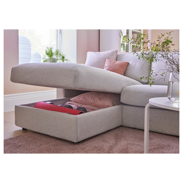 Modern gray sofa with storage, plush cushions, and a chaise. Perfect for cozy living rooms.