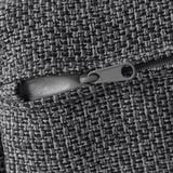 Close-up of zipper on textured gray fabric, showcasing quality.