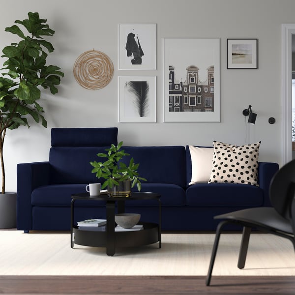 VIMLE navy sofa, modern minimalist design. Centered, its larger than side items.