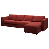 The VIMLE sofa is a deep red, l-shaped design with a chaise longue for comfort, showcasing a modern and cozy aesthetic.