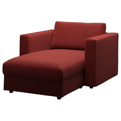 A red VIMLE chaise lounge. Its upholstered in red velvet, featuring a curved seat with storage and square armrests.
