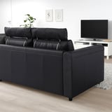 Black VIMLE sofa in minimalist living room with tv and rug.