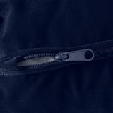 Close-up of black zipper on soft, dark fabric.