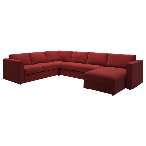 Red l-shaped sofa with velvet cover, deep seating, armrests, square cushions. Minimalist, modern design.