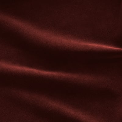 Rich, textured close-up of luxurious dark red velvet fabric, showcasing its soft pile and subtle shine.