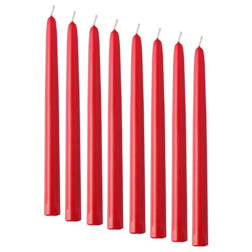 Eight straight red candles lined up, unlit, pure stearin material.