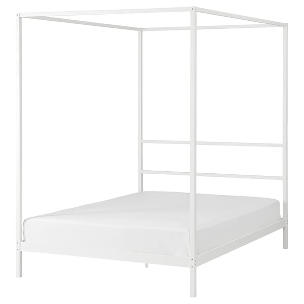 White four-poster bed with modern metallic design, ideal for creating a cozy sleeping nook.