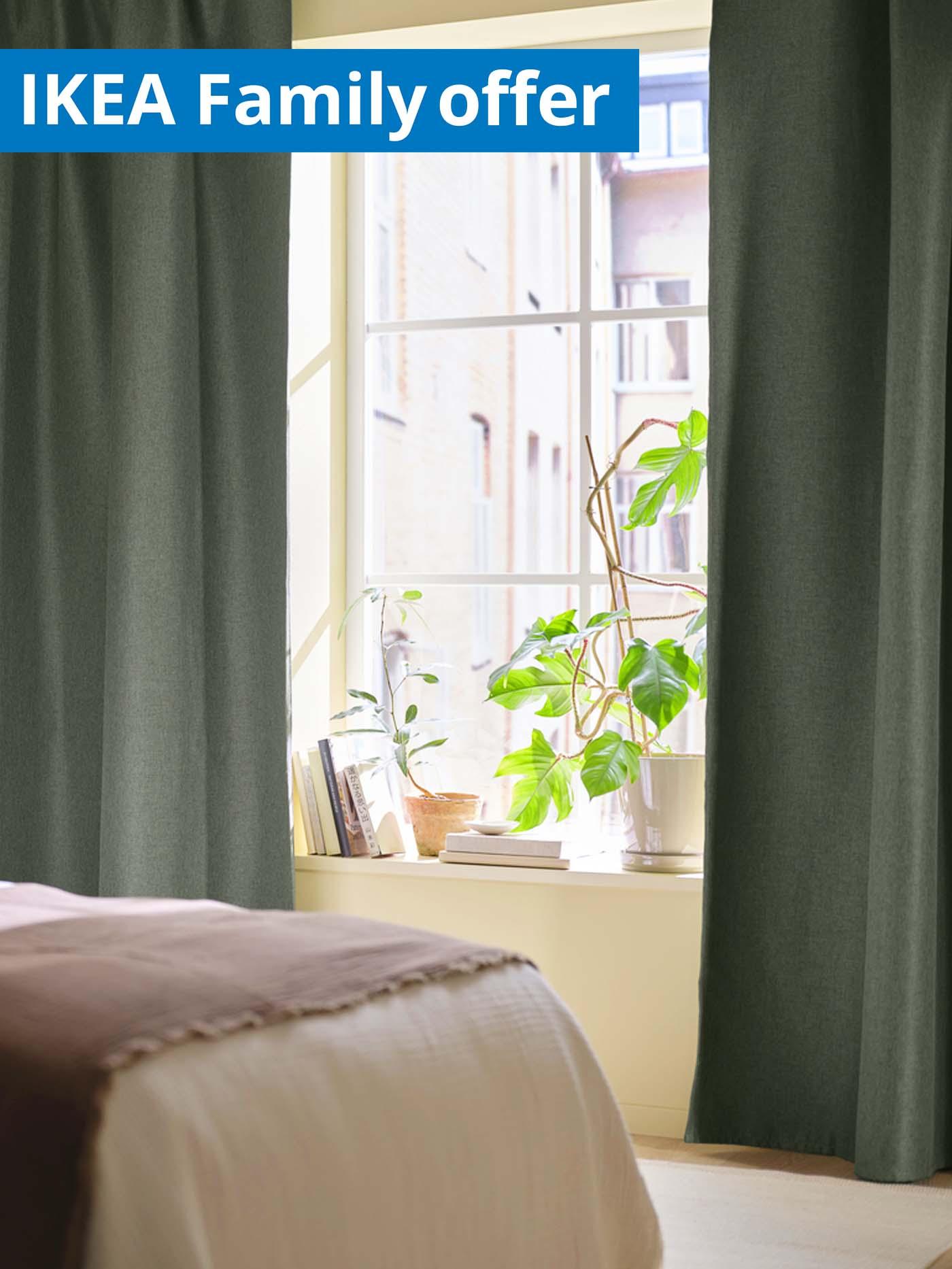 1 - 25 August IKEA Family offer. Dark green ANNAKAJSA curtains hanging from a window with natural light pouring in.