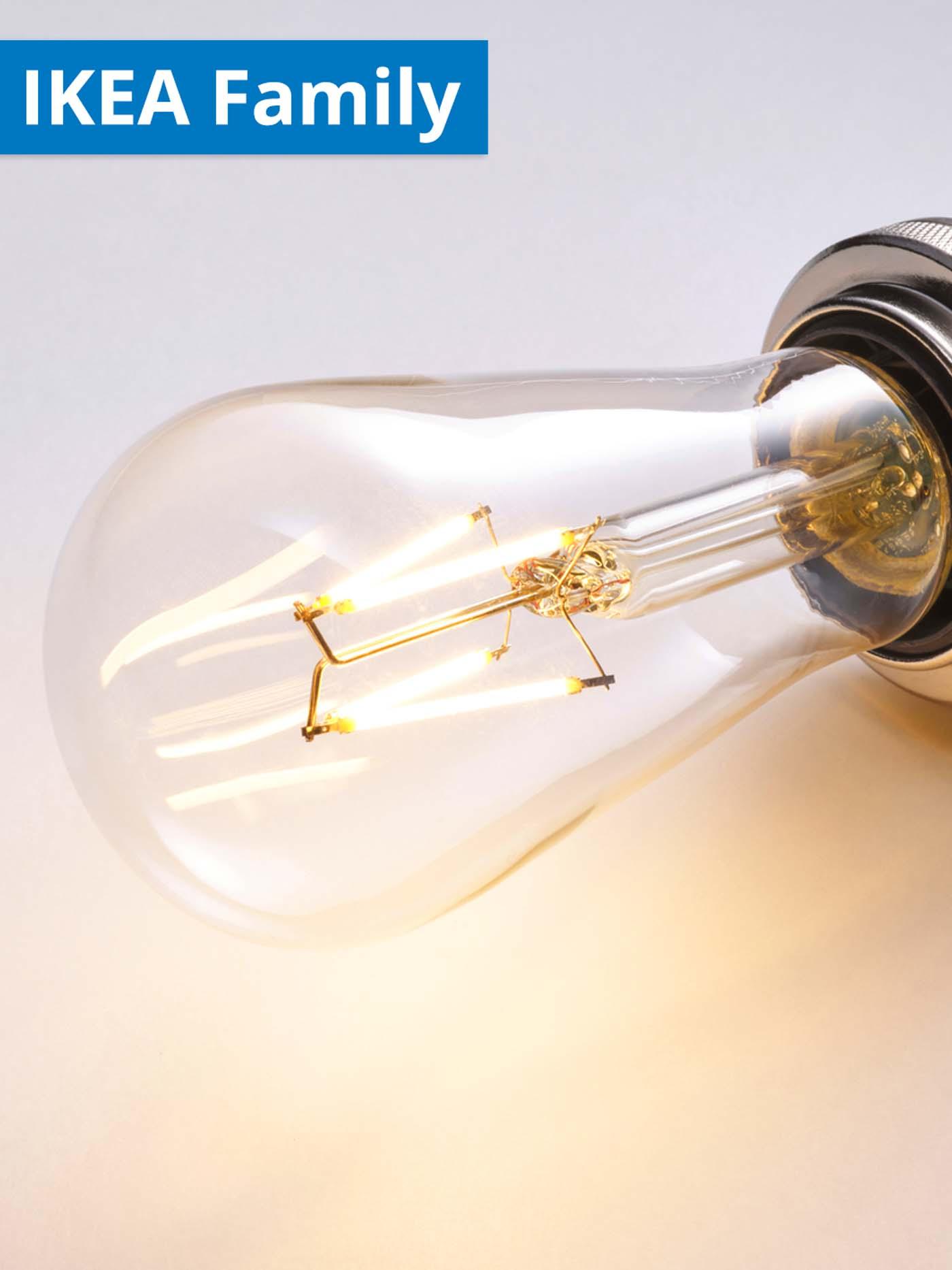 1 - 30 June IKEA Family offer. Close-up shot of a LUNNOM LED bulb E27 150lm drop-shaped clear bulb.