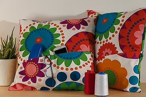 2 colourful patterned cushions from the ÅTERSTÄLLA collection 