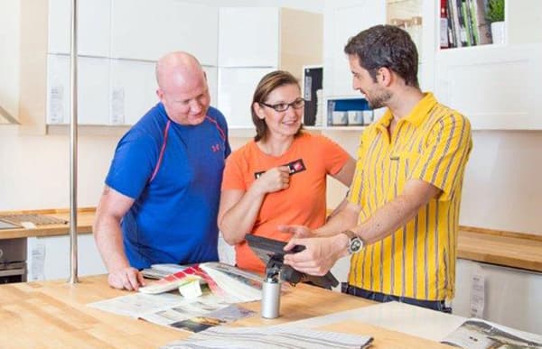 2 customers are discussing with an IKEA employee