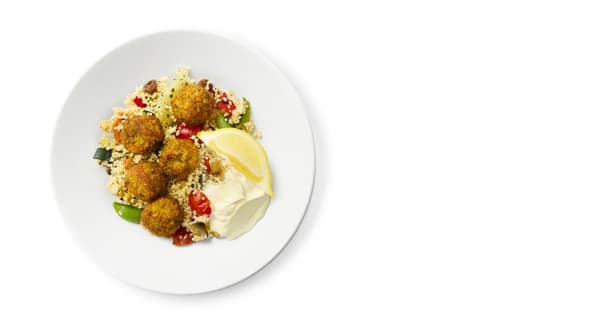 5 pieces of falafel with couscous, vegetables, a dollop of mayonnaise and a slice of lemon