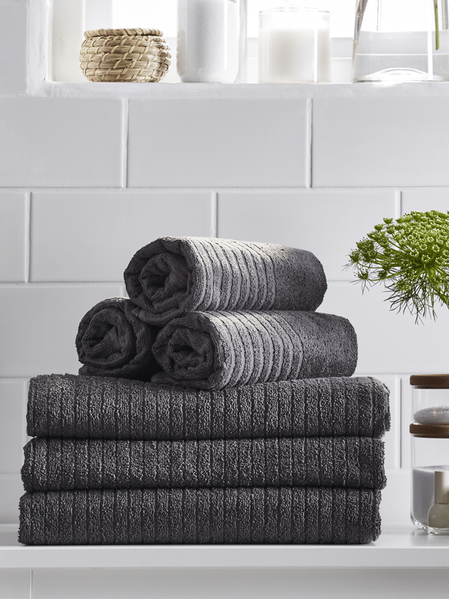 6 dark towels in the bathroom
