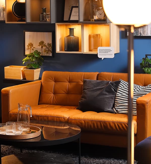 A 3-seat orange sofa with two cushions.