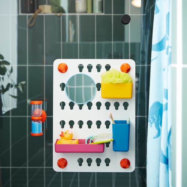 A 6-piece storage board set in mixed colours and an orange hourglass with blue sand are attached on a glass shower door.
