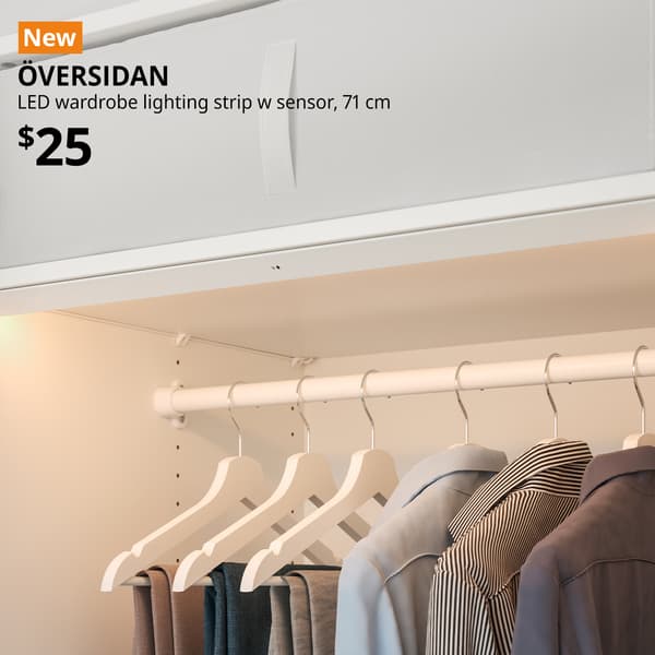 A 71 cm dimmable ÖVERSIDAN LED wardrobe lighting strip with sensor in white. An orange "NEW" label is on the top left of the image with black text that reads: ÖVERSIDAN, LED wardrobe lighting strip with sensor, 71 cm, $25