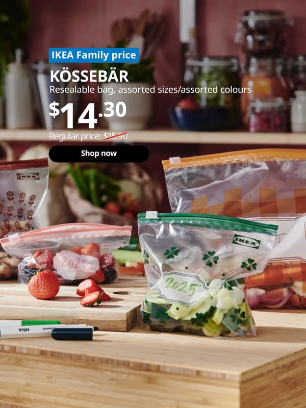 A assorted color and size KÖSSEBÄR resealable bag with cut fruits and vegetables stored in it. Blue tag with white text that reads "IKEA Family price". Followed by white text over image that reads "KÖSSEBÄR, Resealable bag, assorted sizes/assorted colours, Price $14.90" Regular price: $15.90 with red line slashed across.