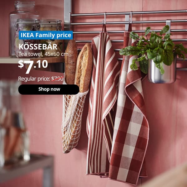 A assorted pattern of KÖSSEBÄR tea towel hung on the wall shelving. Blue tag with white text that reads "IKEA Family price". Followed by white text over image that reads "KÖSSEBÄR, Tea towel, 45x60 cm, Price $7.10" Regular price: $7.90 with red line slashed across.