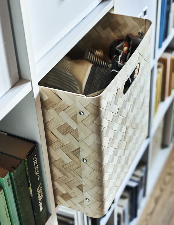 A bamboo box insert in a cubed storage unit.