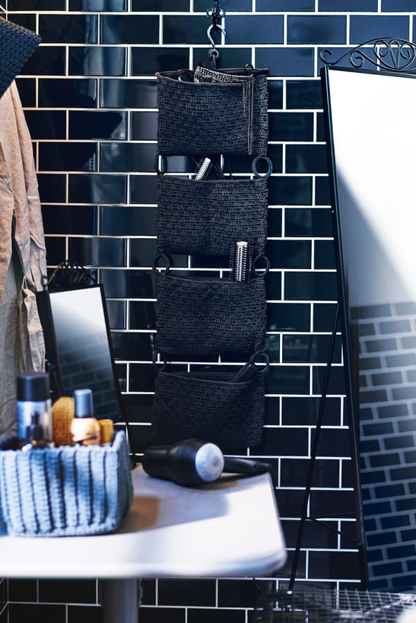 A bathroom wall organiser propped with hair products.