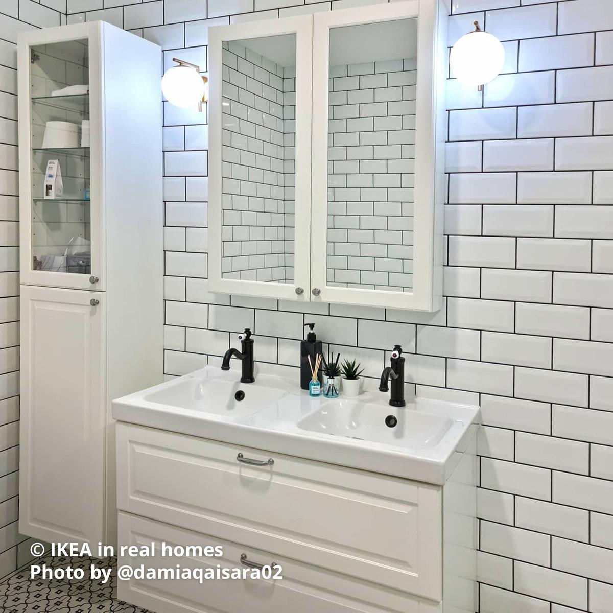 A bathroom with white TÄNNFORSEN high cabinet with door, TÄNNFORSEN mirror cabinet with doors and a TÄNNFORSEN with duo sink in a bathroom setting. IKEA in real homes Photo by @damiaqaisara02.