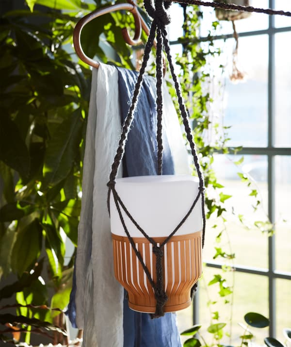 A battery charged MULLBACKA LED table lamp hanging freely.