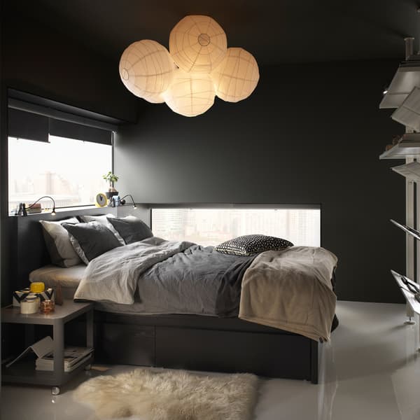 A bedroom area with an IKEA BLÅVINDA grey chambray quilt cover and pillowcases and balloon rice lamps.