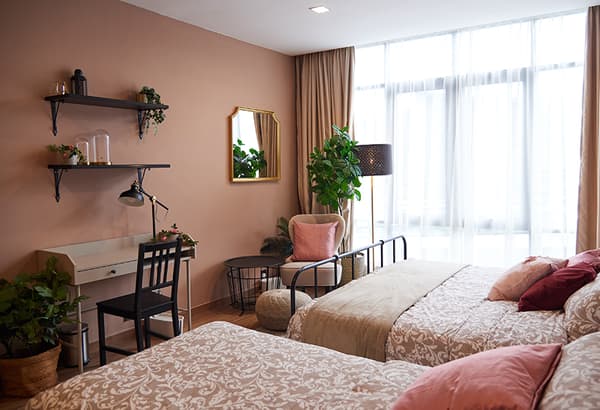A bedroom featuring a white desk, mirror and lamp.