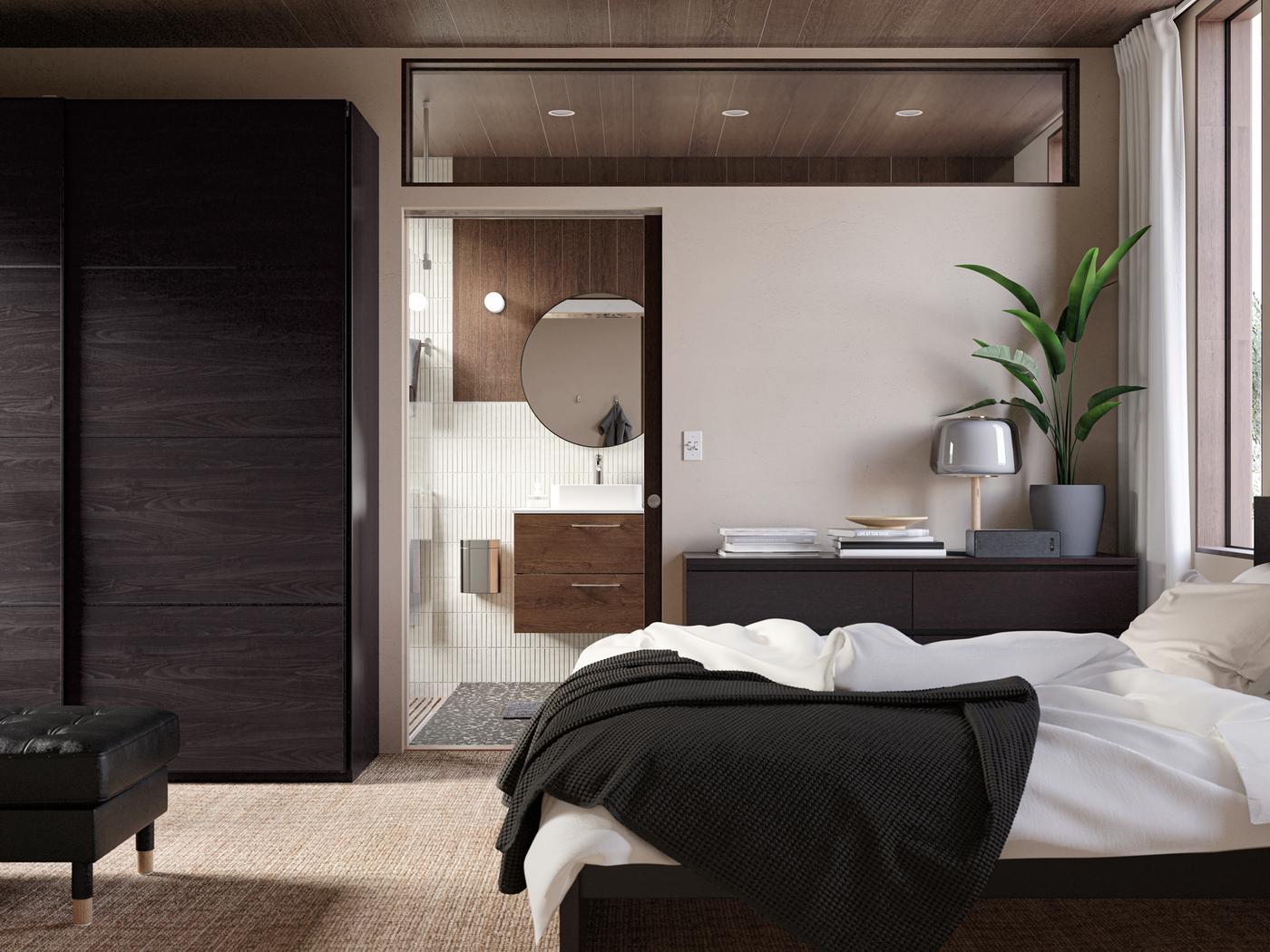 A bedroom with a MALM bed frame and bedroom storage, the door to the bathroom open, a LINDBYN mirror in black on the wall.