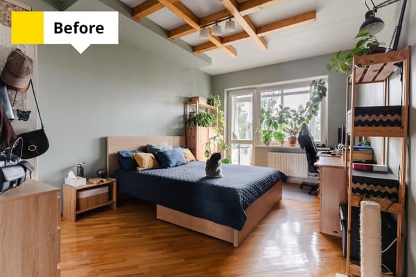 A bedroom with a wooden bed, shelves filled with plants, a workspace by the window and exposed ceiling beams. Text in the top-left corner reads: “Before”.