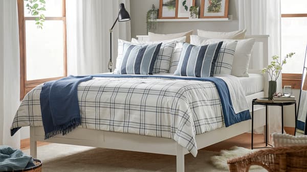 A bedroom with checkered blue and white bedding on it.