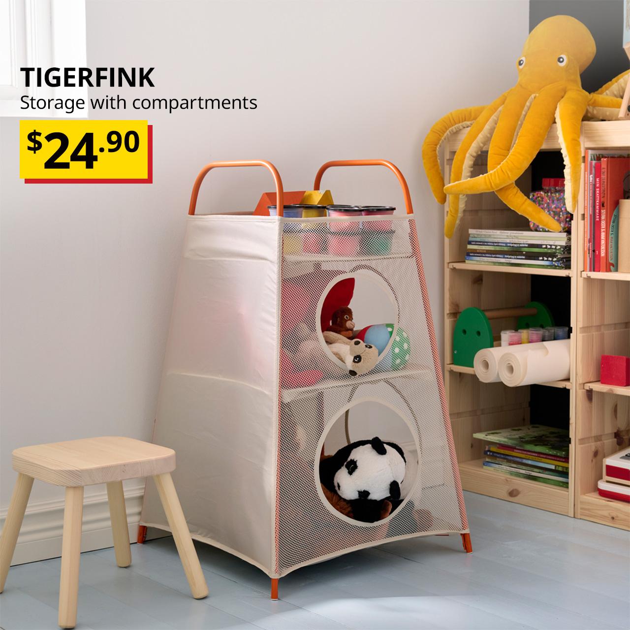 A beige/orange TIGERFINK storage with compartments placed next to a TROFAST storage combination in the children's playroom. Black text overlay image on the top left corner that reads, "TIGERFINK, Storage with compartments", with a breathtaking price tag in yellow/red of $24.90.