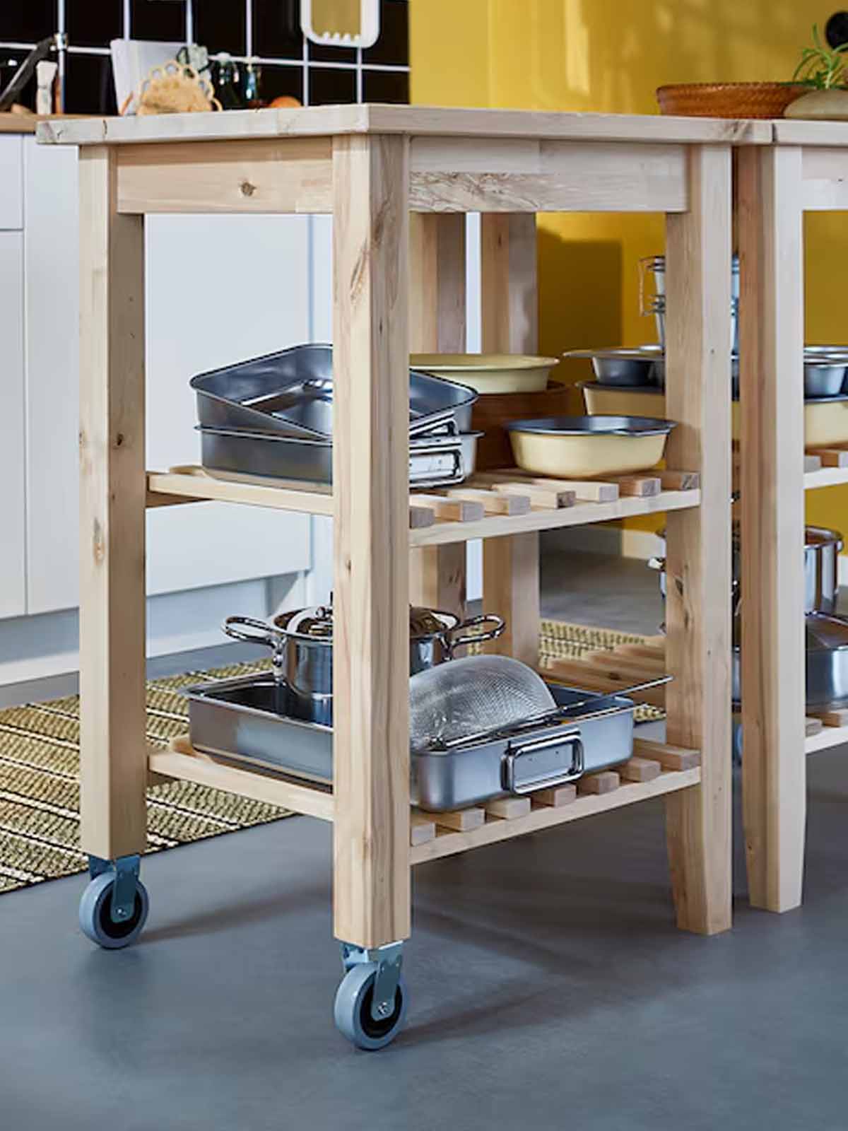 A BEKVAM kitchen trolley filled with various kitchen tools and kitchen accessories in the kitchen.