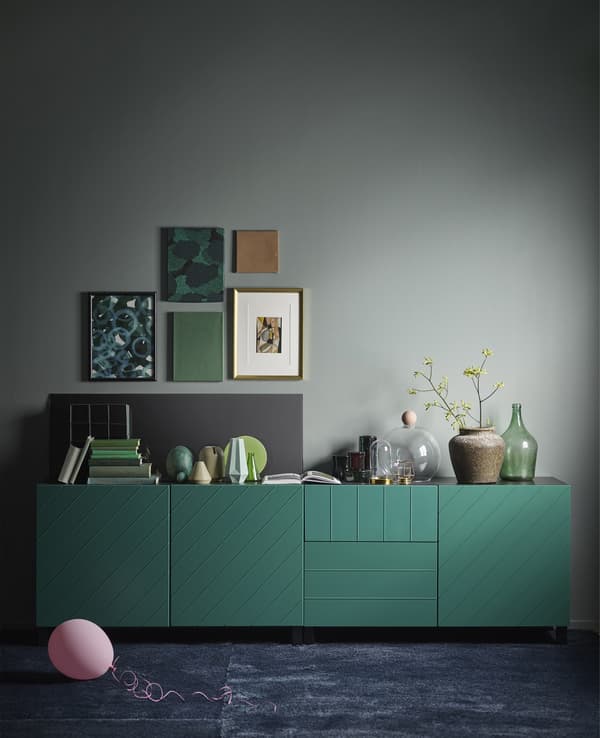 A BESTÅ storage combination in blue-green. The modern, rectangular cabinet has a black-brown frame.