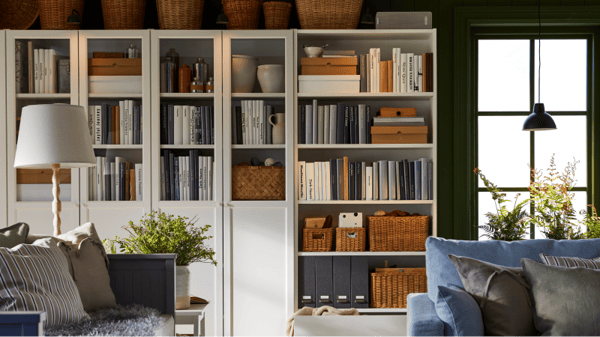 A BILLY cabinet in the lviing room filled with books and accessories.